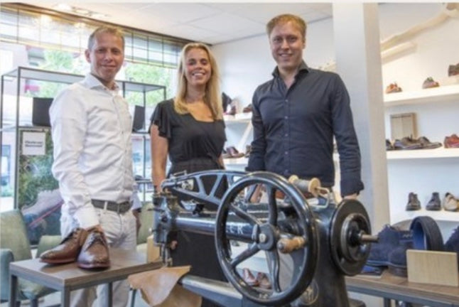 De familie Steenbergen in de winkel bij de oude schoenmakersmachine